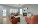 Comfortable living room with hardwood floors, a fireplace, ample seating, and natural light at 5400 Rock Creek Ct, North Charleston, SC 29420