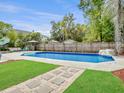 Inviting backyard pool with ample seating, lush landscaping, and privacy fence at 5403 Diston Ct, North Charleston, SC 29420