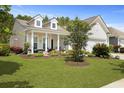 Beautiful home with well-maintained lawn, mature landscaping, and inviting front porch at 559 Eastern Isle Ave, Summerville, SC 29486