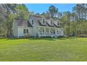 Beautiful exterior view of the home, showcasing the well-maintained lawn and landscaping at 5950 Lowell Reed Rd, Ravenel, SC 29470
