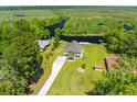 Stunning aerial view of a home with a large yard surrounded by lush greenery and winding waterways at 643 Backfield Rd, Walterboro, SC 29488
