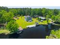 Beautiful waterfront home with green lawn and private dock, surrounded by lush trees at 643 Backfield Rd, Walterboro, SC 29488