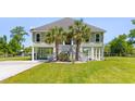 Inviting two-story home featuring a charming staircase entrance and lush palm trees at 643 Backfield Rd, Walterboro, SC 29488