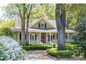 Beautiful house featuring a cozy front porch and lush, flowering garden landscape at 707 Royall Ave, Mount Pleasant, SC 29464