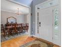 Bright dining room featuring hardwood floors, a chandelier, and an elegant table set for a gathering at 8781 Laurel Grove Ln, North Charleston, SC 29420
