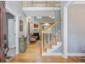 Elegant foyer showcasing hardwood floors, a staircase, and a glimpse into the cozy living room with a fireplace at 8781 Laurel Grove Ln, North Charleston, SC 29420