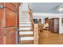 Bright entryway showcases the wooden staircase, hardwood floors and open access to the main living area at 905 Simmons St, Mount Pleasant, SC 29464