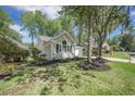 Traditional home featuring manicured front lawn, light siding, and a driveway leading to a garage at 9146 Spring Branch Ct, North Charleston, SC 29406