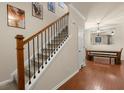 Inviting entryway featuring a carpeted staircase with wooden handrail and open dining space at 9660 Godwin St, Ladson, SC 29456