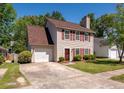 Charming two-story home with red shutters, attached garage, and well-manicured lawn at 109 E Hartwick Ln, Goose Creek, SC 29445
