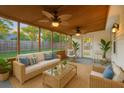 Inviting screened porch with comfortable seating and stylish ceiling fans overlooking fenced backyard at 109 Red Cypress Dr, Goose Creek, SC 29445