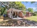 Brick house with covered outdoor seating area, perfect for relaxing or entertaining guests at 1142 Camden St, North Charleston, SC 29405