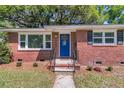 Inviting front door with brick facade, decorative details, and a well-maintained landscaped yard at 1142 Camden St, North Charleston, SC 29405
