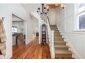 Traditional foyer features wood floors, stairs with carpet runner, and a view of the dining area at 1153 King St, Charleston, SC 29403