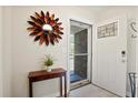 Welcoming entryway featuring light wood flooring, a modern sunburst mirror, and an open door at 119 Savannah Round, Summerville, SC 29485