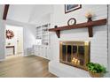 Bright living room with vaulted ceiling, fireplace with brick surround and decorative mantel, and hardwood floors at 119 Savannah Round, Summerville, SC 29485