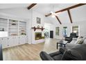 Spacious living room with exposed beams, a cozy fireplace, and built-in shelving, creating a comfortable atmosphere at 119 Savannah Round, Summerville, SC 29485