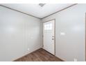 Clean entryway featuring wood-look floors and a white door, offering a simple and inviting welcome at 1330 Whitehouse Rd, Summerville, SC 29486