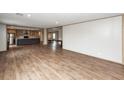 Spacious living area with modern wood-look flooring, open layout to the kitchen, and abundant natural light at 1330 Whitehouse Rd, Summerville, SC 29486