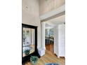Bright foyer featuring hardwood floors, neutral walls, a large mirror, and a glimpse into the living area at 1500 Trumpet Vine Ct, Mount Pleasant, SC 29466
