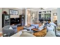 Cozy living room featuring hardwood floors, neutral walls, stylish furniture, and access to the outdoor patio at 1500 Trumpet Vine Ct, Mount Pleasant, SC 29466