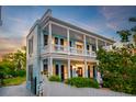 Charming two-story home boasting a spacious porch, elegant columns, and manicured landscape at 154 Wentworth St, Charleston, SC 29401