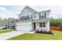 Beautiful two-story home with a welcoming front porch and well-maintained lawn, in a friendly neighborhood at 158 Boots Branch Rd, Summerville, SC 29485