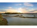 Beautiful sunrise over the tranquil creek with marshlands, docks and islands at 1637 Folly Creek Way # E-12, Charleston, SC 29412