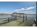 View of boat docked near marsh, with boat lift and dockside pilings at 1637 Folly Creek Way # E-12, Charleston, SC 29412