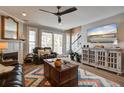 Cozy living room features a fireplace, leather sofas, ceiling fan, and sliding glass doors at 1637 Folly Creek Way # E-12, Charleston, SC 29412