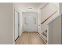 Bright entryway featuring hardwood floors, stairs with carpet runner, and white trim at 168 Keaton Brook Dr, Summerville, SC 29485