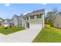 Beautiful two-story home on a green lawn with a concrete driveway at 1728 Refuge Dr, Ladson, SC 29456