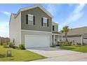 Beautifully landscaped two-story home featuring gray siding and a spacious two-car garage at 183 Greenwich Dr, Summerville, SC 29486