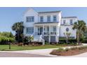 Charming two-story home with landscaped yard, inviting front porch, and a classic white exterior with gray trim at 1905 Lone Oak Pt, Mount Pleasant, SC 29466