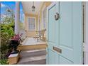 Charming front porch with a teal door, bench, and white railing, offering a cozy outdoor space at 197 Coming St, Charleston, SC 29403