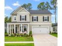 Charming two-story home with manicured lawn, dark shutters, and a two-car garage at 206 Red Bluff St, Summerville, SC 29483