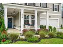 Inviting front porch with white columns, stylish door, and manicured landscaping at 206 Red Bluff St, Summerville, SC 29483