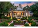 Inviting brick home boasts manicured landscaping and a decorative fountain feature at 207 Central Ave, Summerville, SC 29483