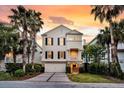 Inviting home with a brick-accented garage and a cozy front porch at 21 Morgan Place Dr, Isle of Palms, SC 29451