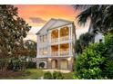 Elegant two-story home featuring double porches and well-manicured landscaping at 21 Morgan Place Dr, Isle of Palms, SC 29451