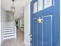 Inviting foyer with a blue front door, hardwood floors, and stairs leading to the upper level at 2282 Braided Ln, Mount Pleasant, SC 29466