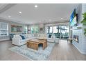 Bright living room with a cozy fireplace, large sectional sofa, and access to the outdoor patio at 2282 Braided Ln, Mount Pleasant, SC 29466