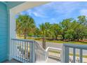 Scenic view from the porch showcasing lush trees and a tranquil community pond at 2302 Hamlin Sound Cir, Mount Pleasant, SC 29466