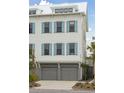 Three-story home with a two-car garage and beautiful light blue window shutters at 2568 Helmsman Rd, Johns Island, SC 29455