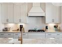 A kitchen featuring white cabinets, stone countertops, and stainless steel appliances at 2568 Helmsman Rd, Johns Island, SC 29455