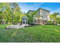Expansive backyard featuring a lush lawn, patio area with seating, and a picturesque view of surrounding greenery at 2668 Private Lefler Dr, Johns Island, SC 29455