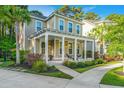 Inviting two-story home boasts a spacious front porch with stylish seating and professionally landscaped surroundings at 2668 Private Lefler Dr, Johns Island, SC 29455