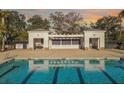 Sparkling community pool with marked lanes, surrounded by lush greenery and a charming pergola at 2889 Backman St, Mount Pleasant, SC 29466