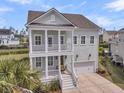 Charming two-story home with double porches, stately columns, and a two-car garage, perfect for coastal living at 2906 Quarterdeck Ct, Mount Pleasant, SC 29466
