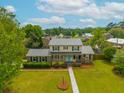 An aerial view of the home displays the beautifully maintained yard and complemented by the light blue front door at 310 Land O Pines Cir, Moncks Corner, SC 29461